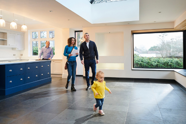 Interracial couple with toddler viewing a house.